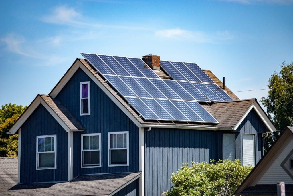 a two-story home with solar panels installed